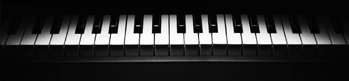 A dimly lit piano keyboard